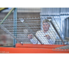Wire deck being placed into pallet rack