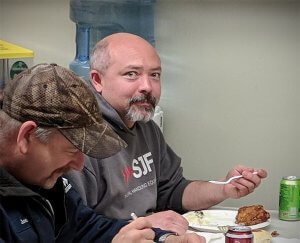 Joe Bachel and Matt Johnson enjoy some of the best chicken in Winsted at SJF's Employee Appreciation Dinner