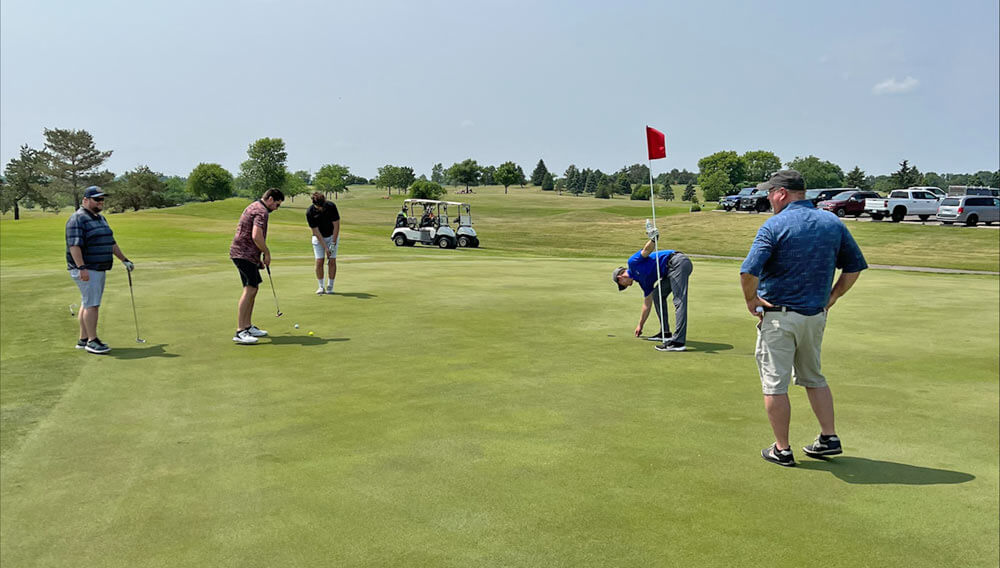 Golfers in action at the "unofficial" SJF vs. Destination Transport Golf Scramble