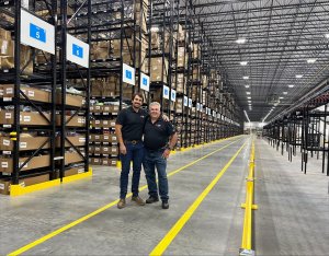 Sam and Frank Sterner in a warehouse