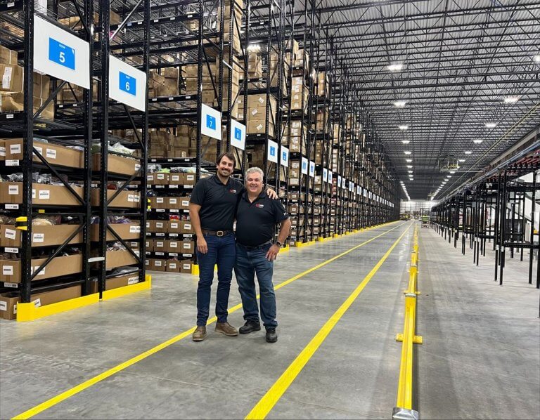 Sam and Frank Sterner in a warehouse
